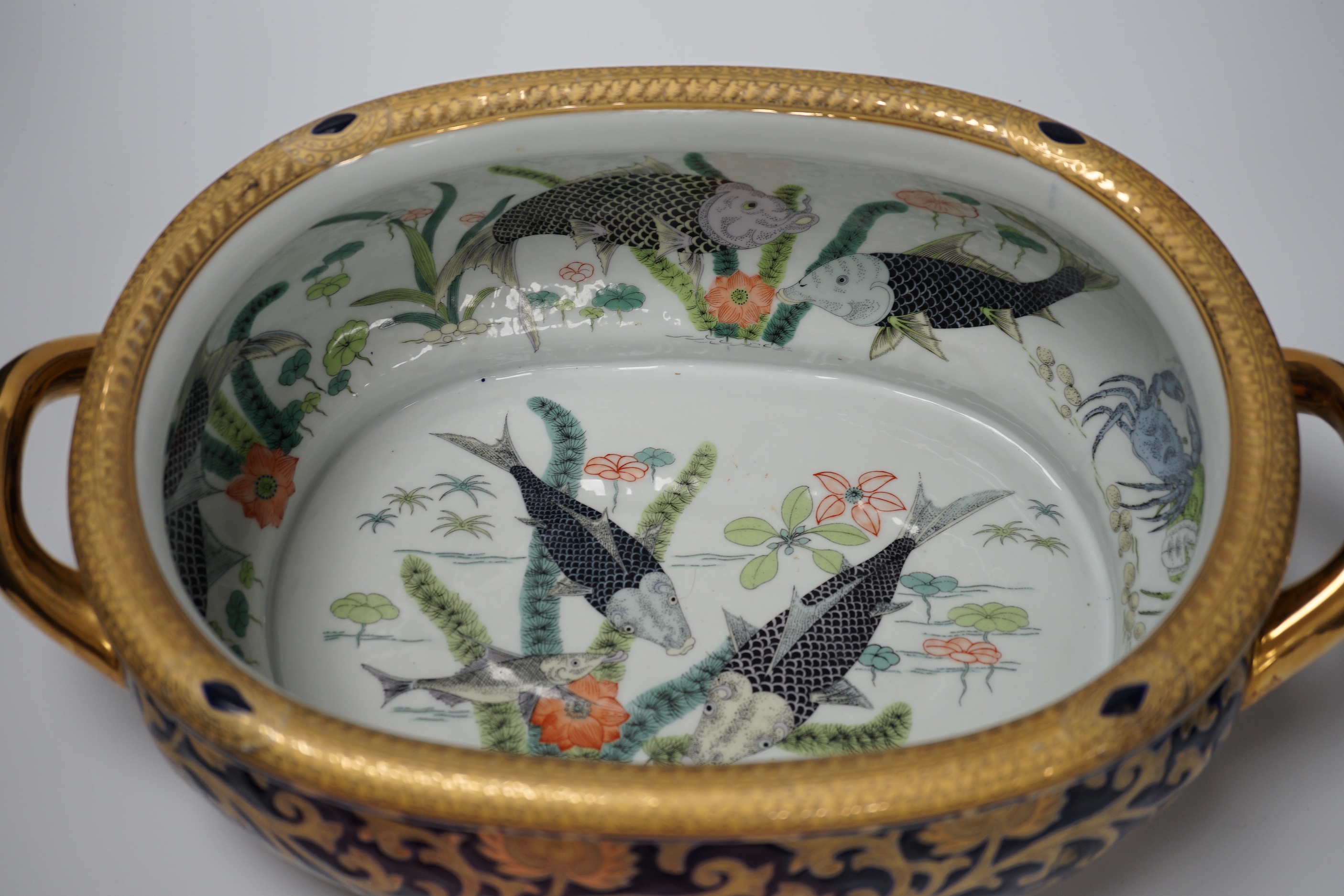 A large Chinese porcelain twin handled bowl decorated with fish and flowers, 44cm wide